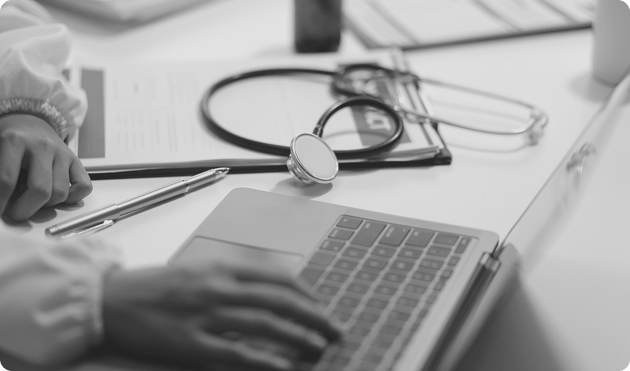 Medical professional using laptop and stethoscope