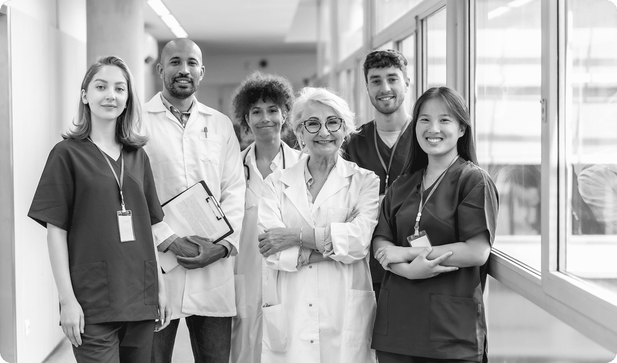 Medical team smiling in hospital corridor